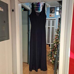 Joseph Ribkoff black long sleeveless dress with gold tone chain accent.
